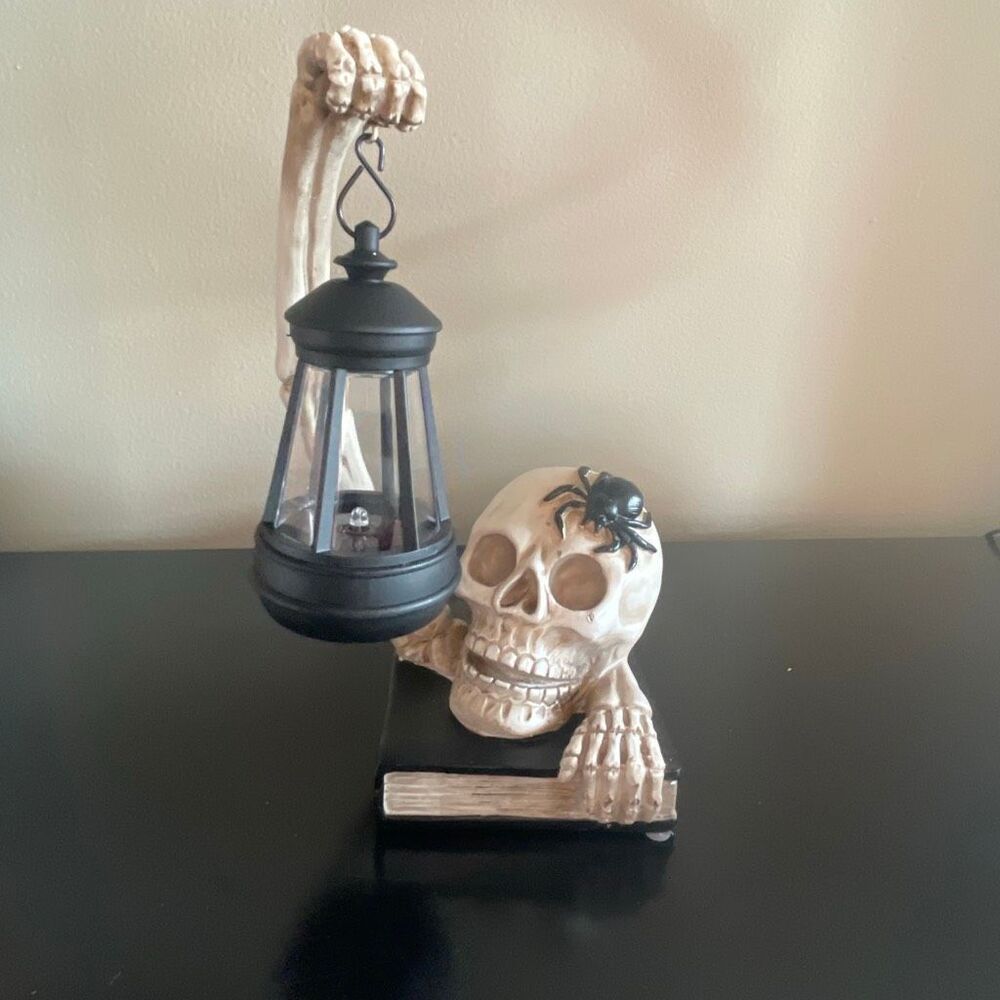 Solar powered lantern Halloween skeleton holding light library window garden
